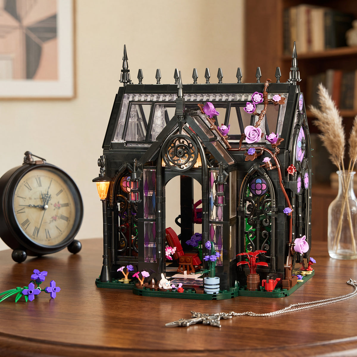 Gothic Greenhouse with pointed black frames, purple flowers and stained-glass details displayed on a wooden table beside a vintage-style clock