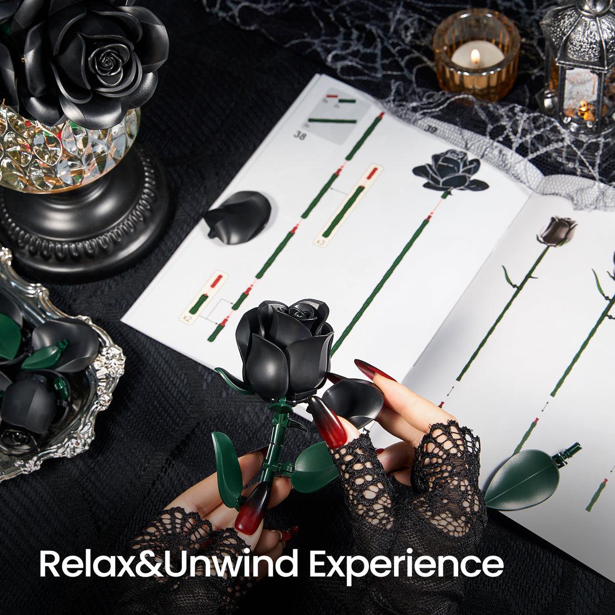 A person assembling a black rose building block set, holding a rose piece with instruction pages and completed black rose arrangements displayed on a dark decorative table.