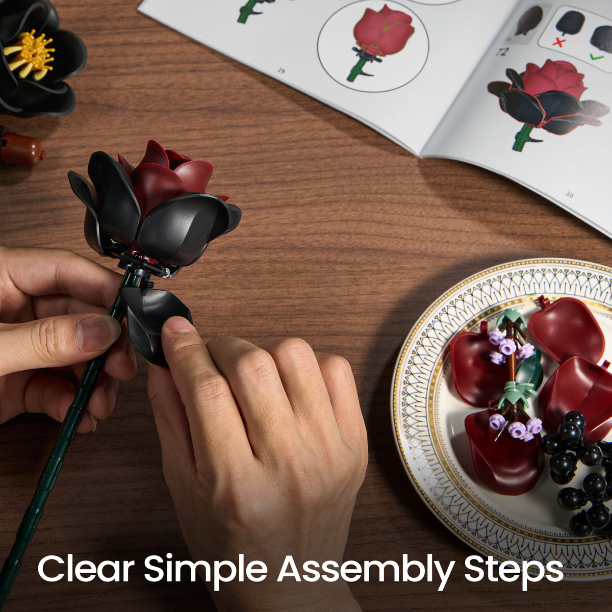 Gothic flower bouquet building set assembly process showing hands attaching flower pieces with instruction guides and components on a tabletop.