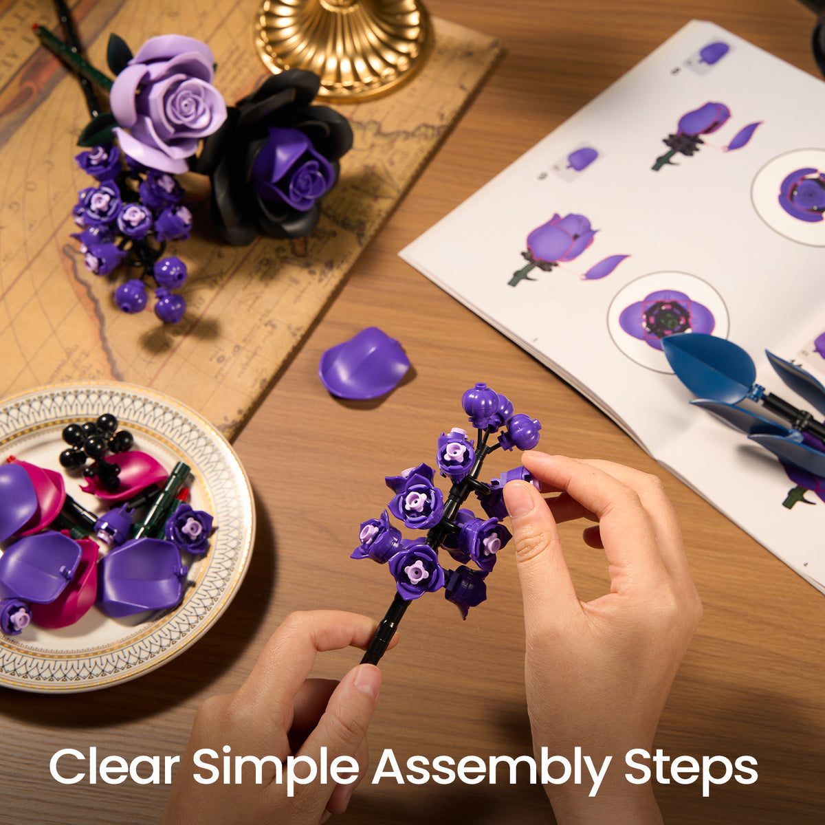 Purple roses bouquet building block set assembly scene showing instruction guides and floral pieces arranged on a tabletop for easy building.