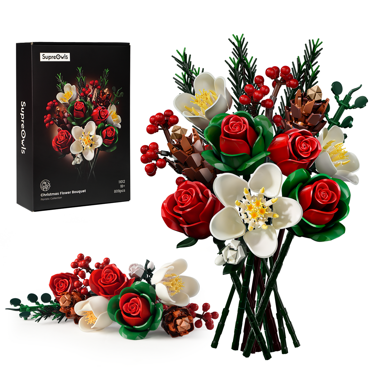 Christmas rose brick bouquet building block set displayed with a completed festive bouquet and product packaging, featuring red roses, white flowers, green leaves, berries, pine branches, and holiday floral details on a white background.