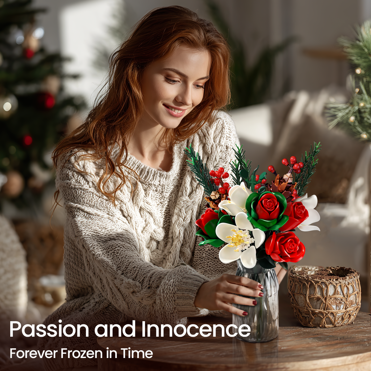A woman displaying a Christmas rose brick bouquet building block set in a glass vase at home, featuring red roses, white flowers, green leaves, red berries, and pine branches in a warm holiday interior setting.