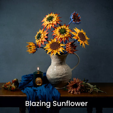 Blazing Sunflower building blocks bouquet with golden, orange and blue blooms displayed in a vase on a table