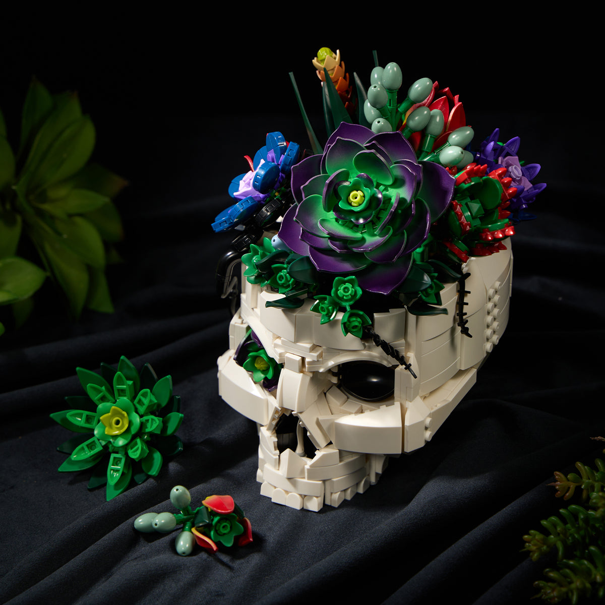 Gothic skull succulent bouquet building block set featuring vibrant green succulent flowers and colorful botanical details displayed as a dark decorative centerpiece.