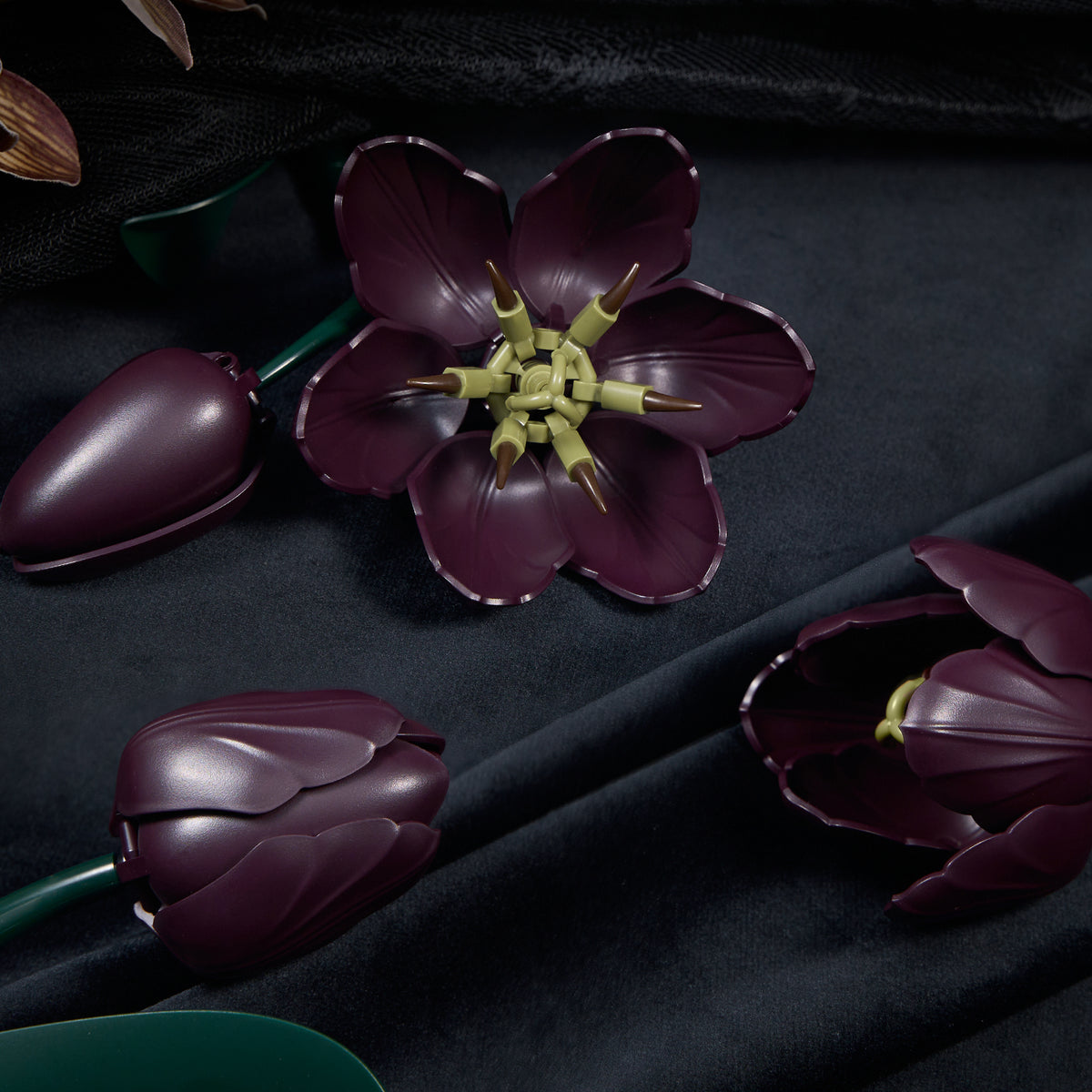 Dark purple tulip building block flower detail featuring realistic petals, detailed flower cores, and a gothic botanical design aesthetic.