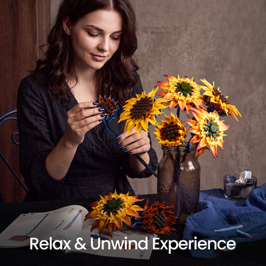 Woman assembling a Blazing Sunflower building blocks bouquet with golden and orange flowers at a table