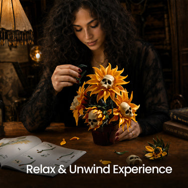 Woman assembling the Skull Sunflower Potted building set with golden sunflower petals and skull centers in a dark pot on a wooden table, with an open booklet nearby.