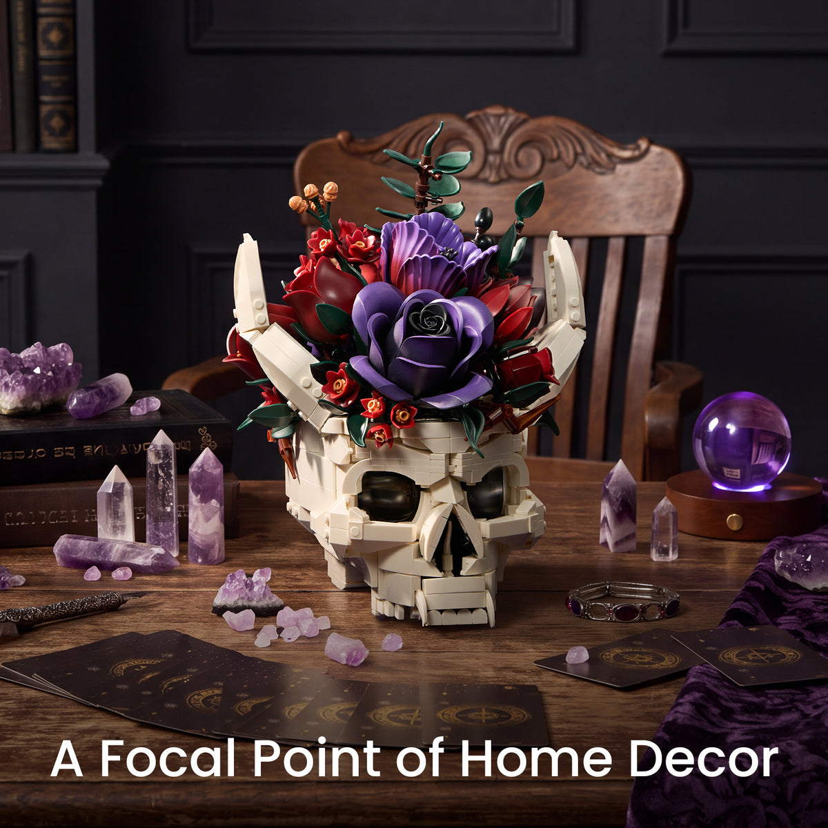 Gothic skull decor with purple and red flowers displayed on a wooden table surrounded by purple crystals and dark decorative objects