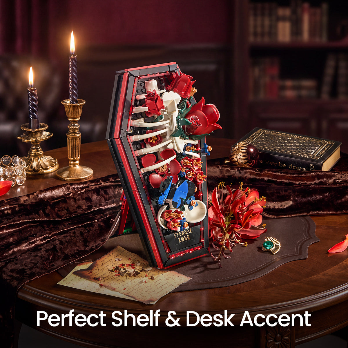 SupreOwls Coffin of Roses building block set displayed on a gothic-style desk with red roses, skeleton ribs, blue butterflies and candlelight.