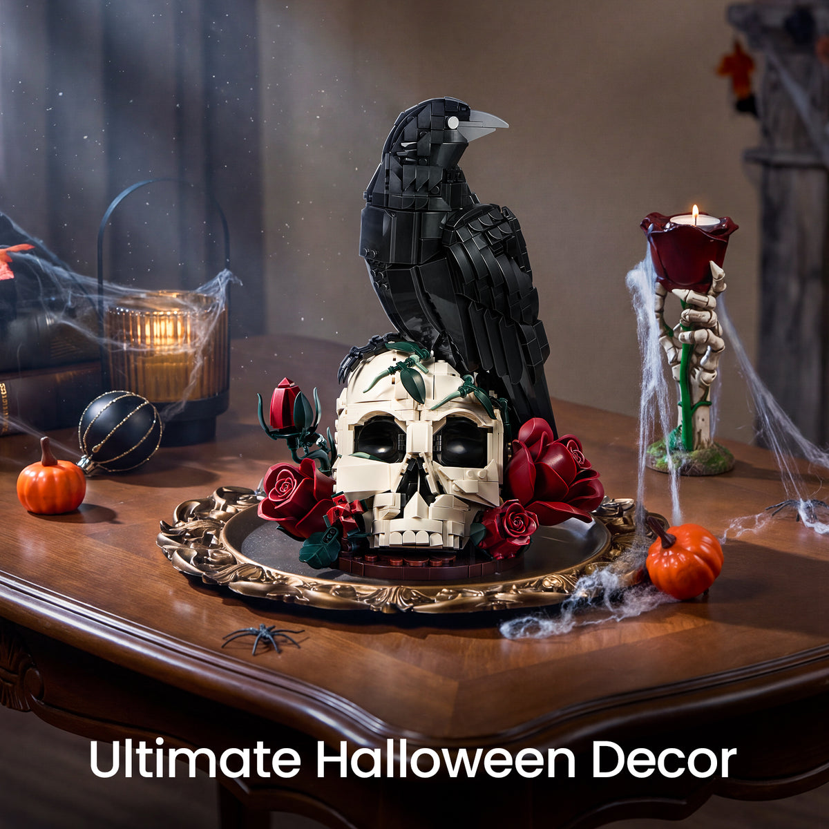 Raven Halloween decor with a black raven perched on a skull and red roses, displayed on a table with pumpkins, candles and cobwebs
