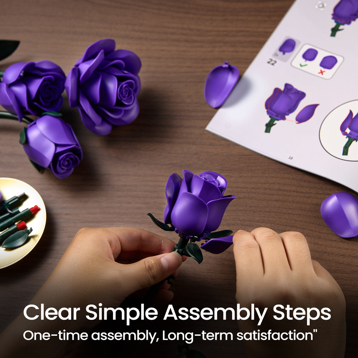 Purple rose bouquet building block set showing simple DIY assembly steps with flower pieces, instruction guide, and hands building a realistic rose.