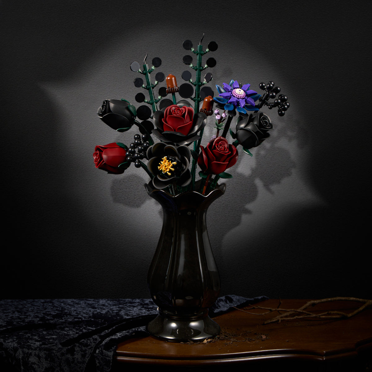 Gothic flower bouquet building set displayed in a black vase, featuring dark roses, purple flowers, and unique botanical details in a moody dark interior setting.